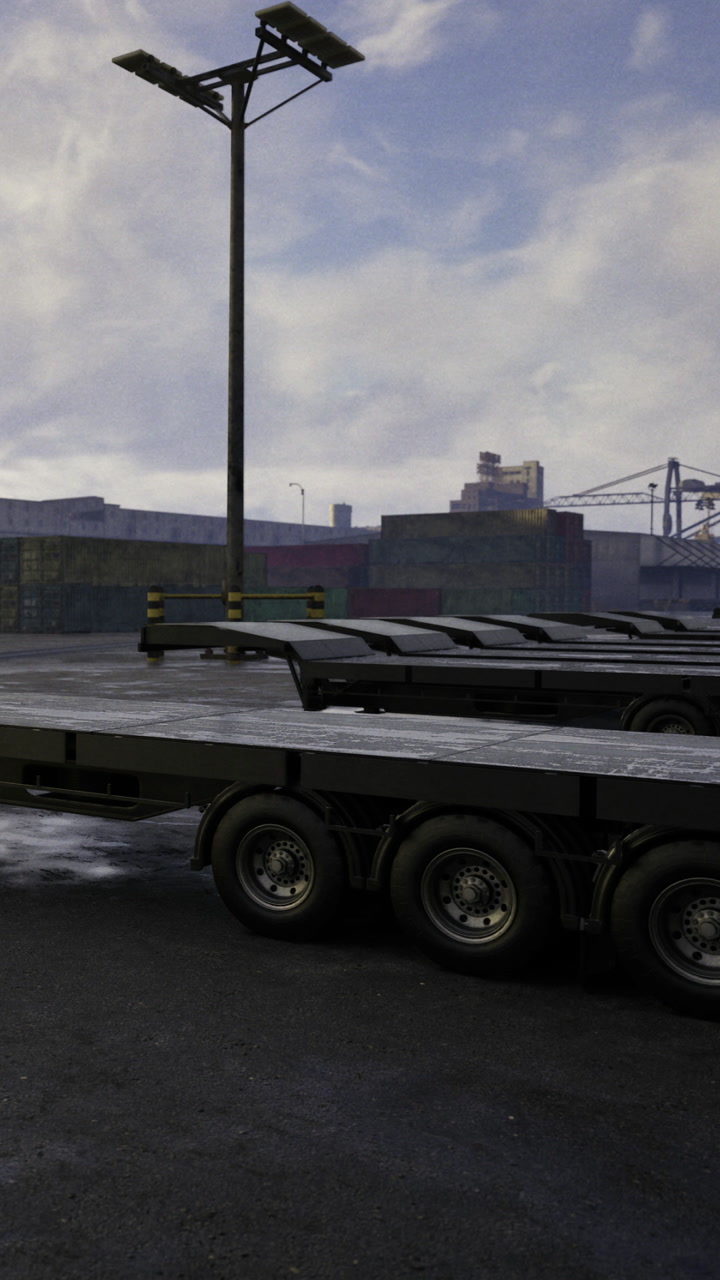 Truck trailers parked in a busy industrial area during late afternoon hours