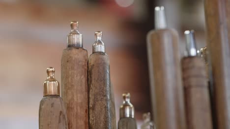 detail of glass whistles with wooden handles in the glassworks