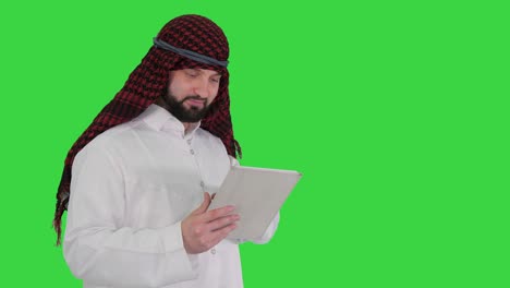 arabic business man with tablet on a green screen, chroma key