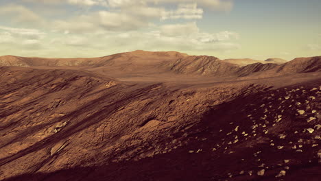 explore the barren landscape of rugged mountains under a bright sky