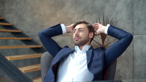 productive businessman relaxing after work on laptop