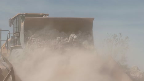 wheel loader throwing stones taken from a stone quarry onto a ramp