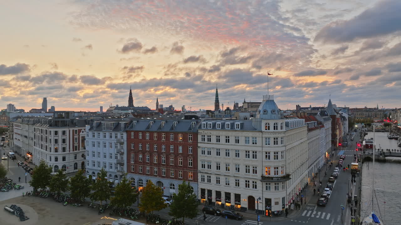 Aerial drone view of the Nyhavn waterfront, canal and entertainment district in Copenhagen, Denmark in the evening