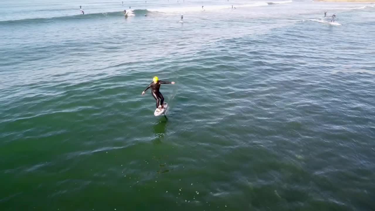 Man Riding an eFoil on Ocean Waves