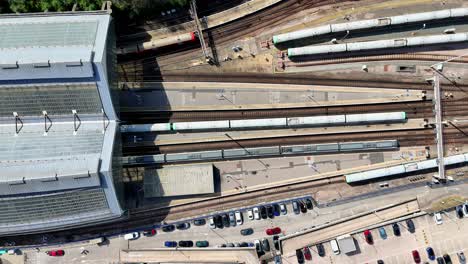 vibrant aerial footage captures brighton’s historic train station, bustling with activity as trains arrive and depart, highlighting the city’s lively atmosphere and its popularity.
