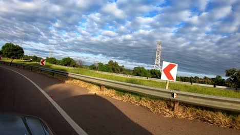 taking a turn from one highway or freeway to another highway or freeway, underneath a bridge.