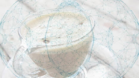 glass cup holding creamy cereal drink getting surrounded by glowing blue network hologram overlay