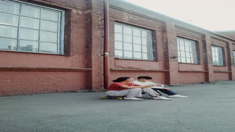 couple relaxing on skateboard outdoors