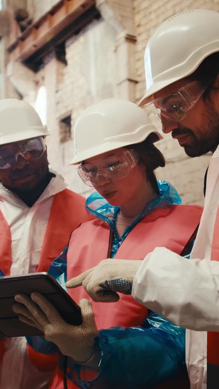Construction Team Reviewing Plans on Tablet