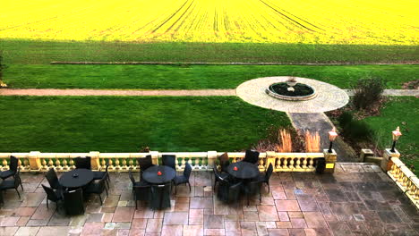 view from leicestershire manor house overlooking courtyard with alfresco setting and green paddocks beyond