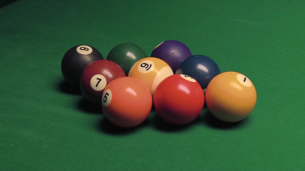 Pool game at a bar. Some call it billiards. Pool shot or break.