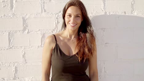 Happy-relaxed-woman-standing-in-the-summer-sun