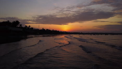 warm and vibrant tropical travel destination of mui ne with sandy coast and silhouette of palm tree in early morning