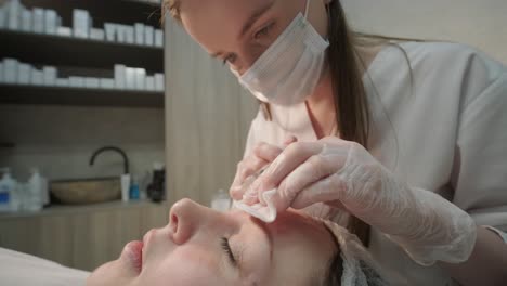 cosmetologist performing facial injection procedure