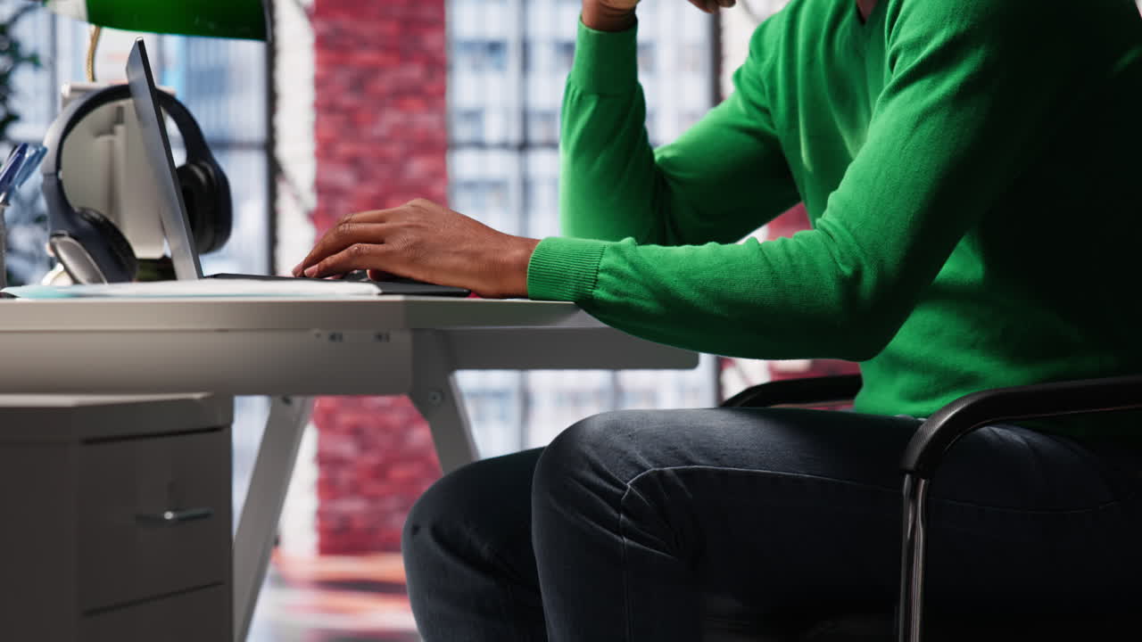 Vertical Video Black teleworker shaking his leg under the desk and acting unsettled