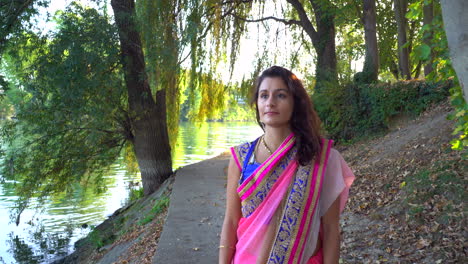 woman in saree walking in forest