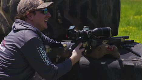 observant marksman at rifle range, aiming rifle during precision match