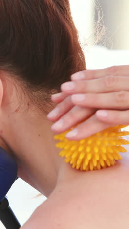 woan having back massage with massage ball