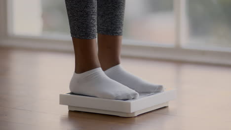 woman standing on a weight scale