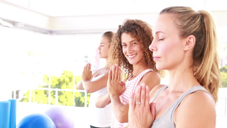smiling athletic women standing in yoga position