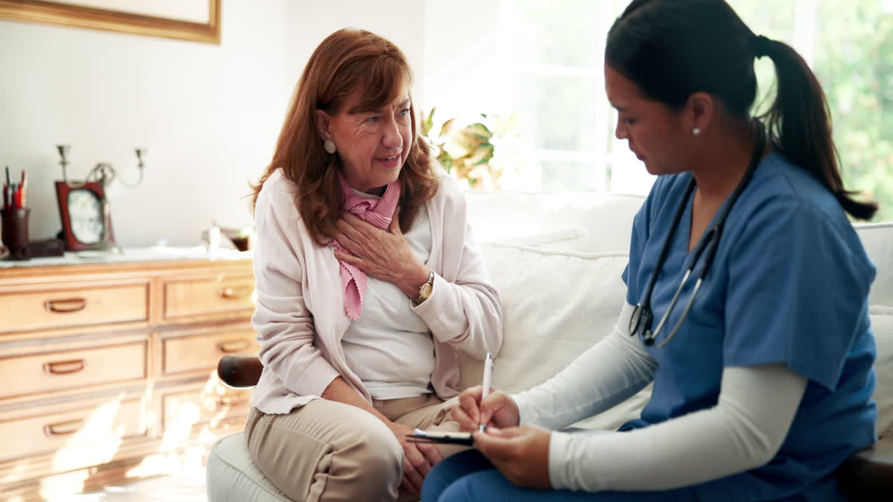 Nurse visiting elderly patient at home