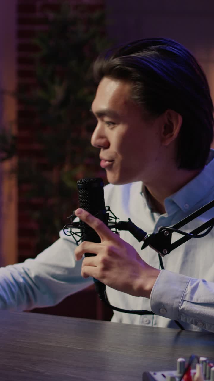 Podcast Studio with Asian Man Recording Audio