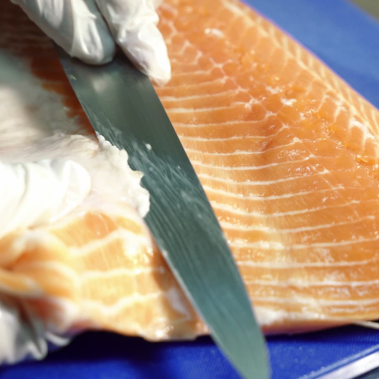Cutting salmon with knife