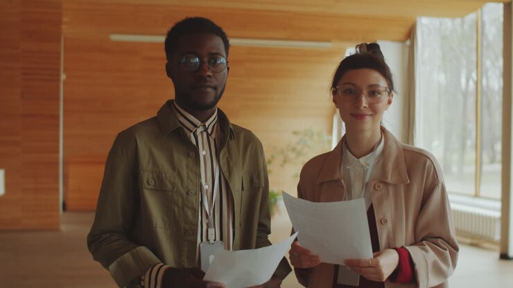Portrait of Positive Afro Man and Caucasian Woman in Auditorium