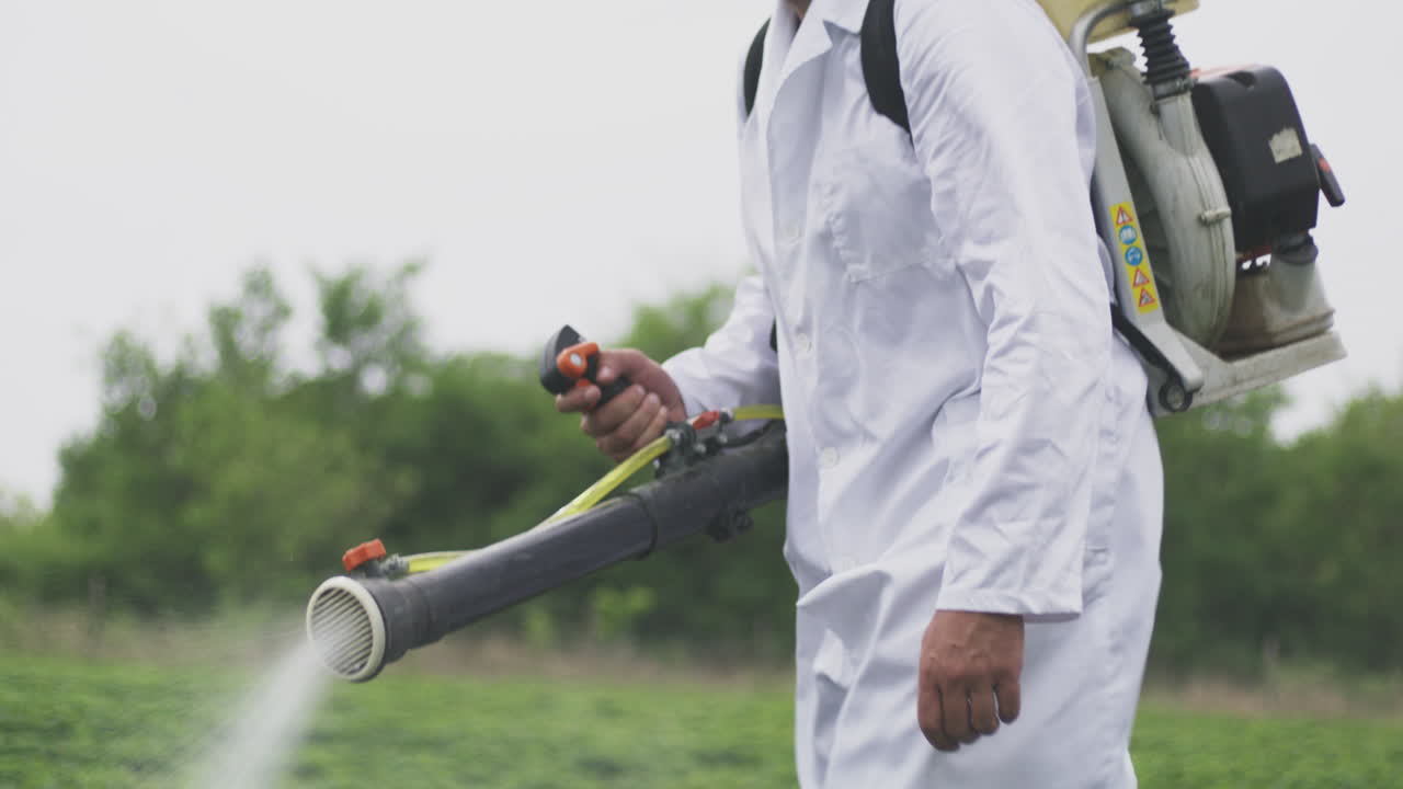 Farmer Spraying Pesticides on Crops