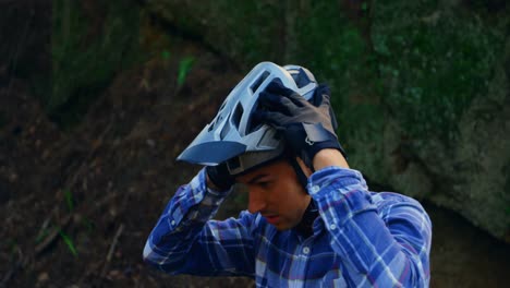 Man-wearing-helmet-in-forest-at-countryside-4k