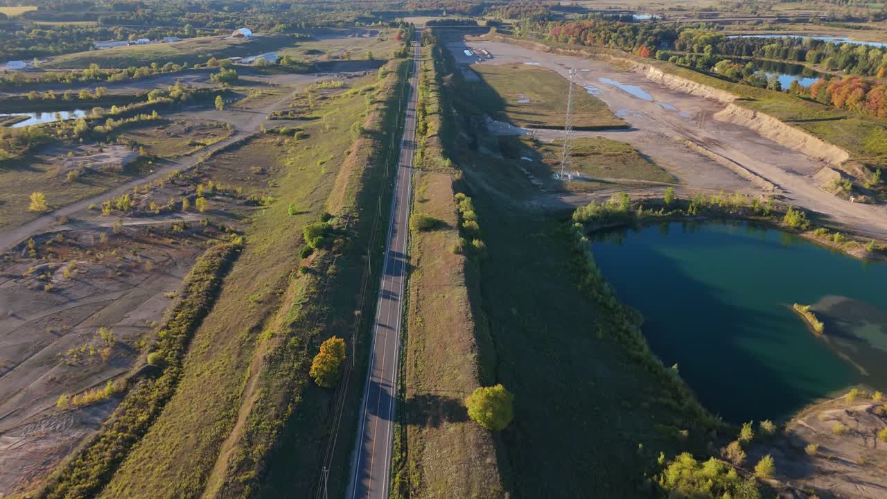 Aerial view of gravel pit and lush landscape on a sunny day