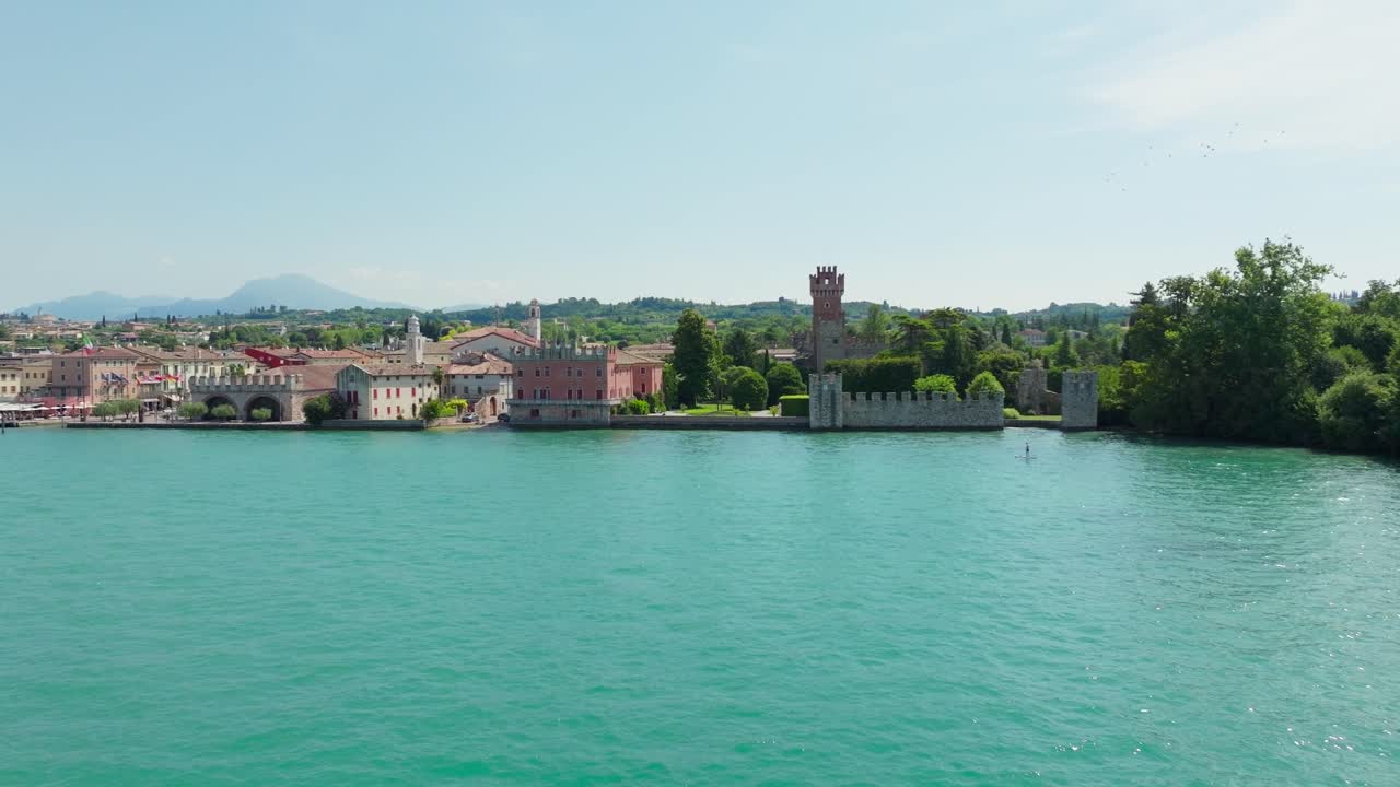 Stunning drone footage capturing the medieval castle of Lazise on the edge of Lake Garda, Italy