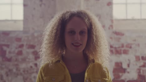 Fashionable-young-woman-in-an-abandoned-warehouse