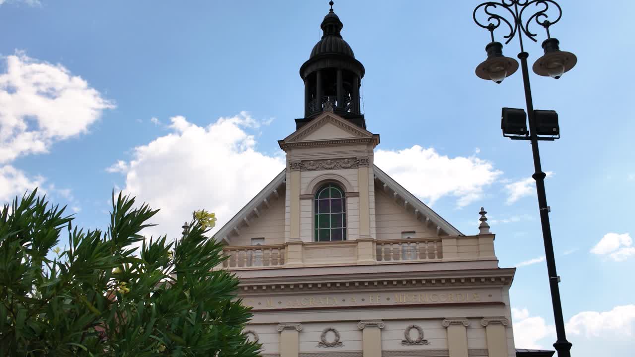 Front view of Saint Sebastian’s Church in Pécs, highlighting its ornate facade and historic baroque architectural details