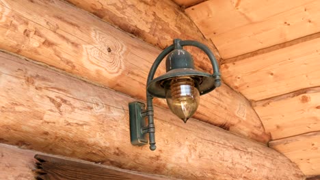 lamp on the log house of chopped logs.