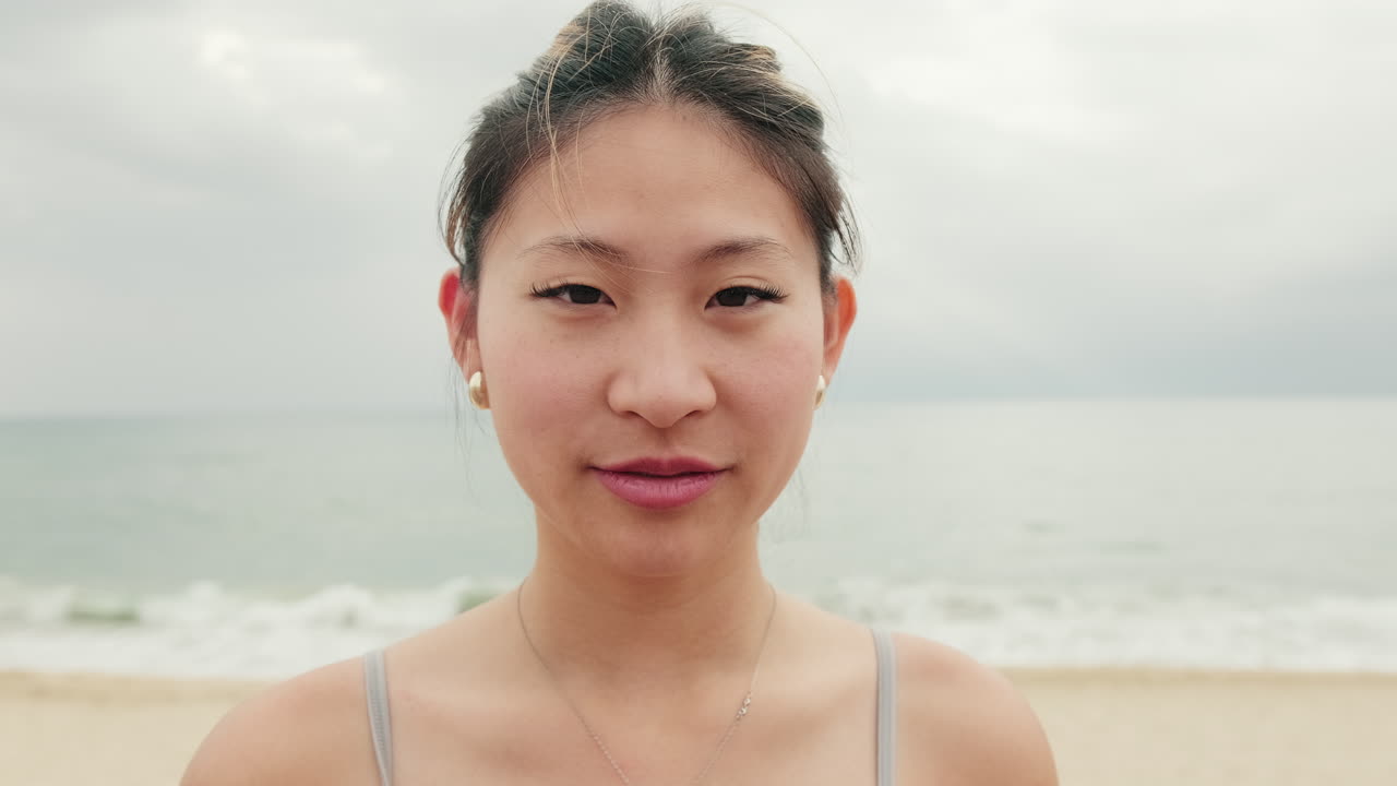 Serene Woman on Beach Smiling at Camera