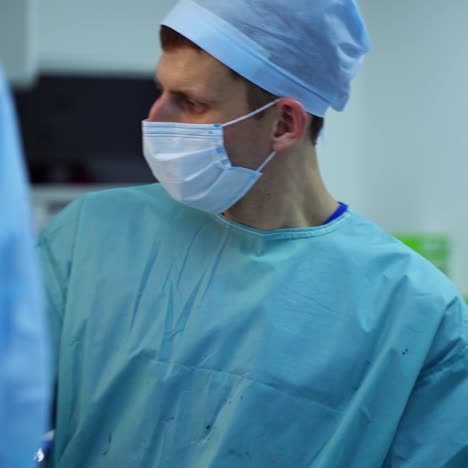 male surgeon in the operating room. professional doctor in medical mask and uniform doing a surgery. portrait of a working surgeon in clinic.