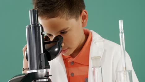 Schoolboy-looking-through-microscope-in-laboratory-4k