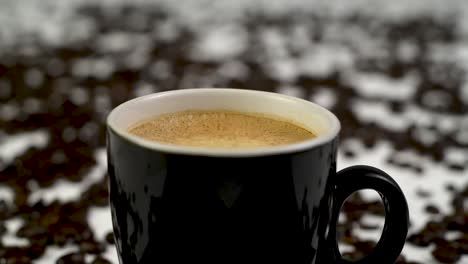 steady shot of a cup of coffee and stirring it