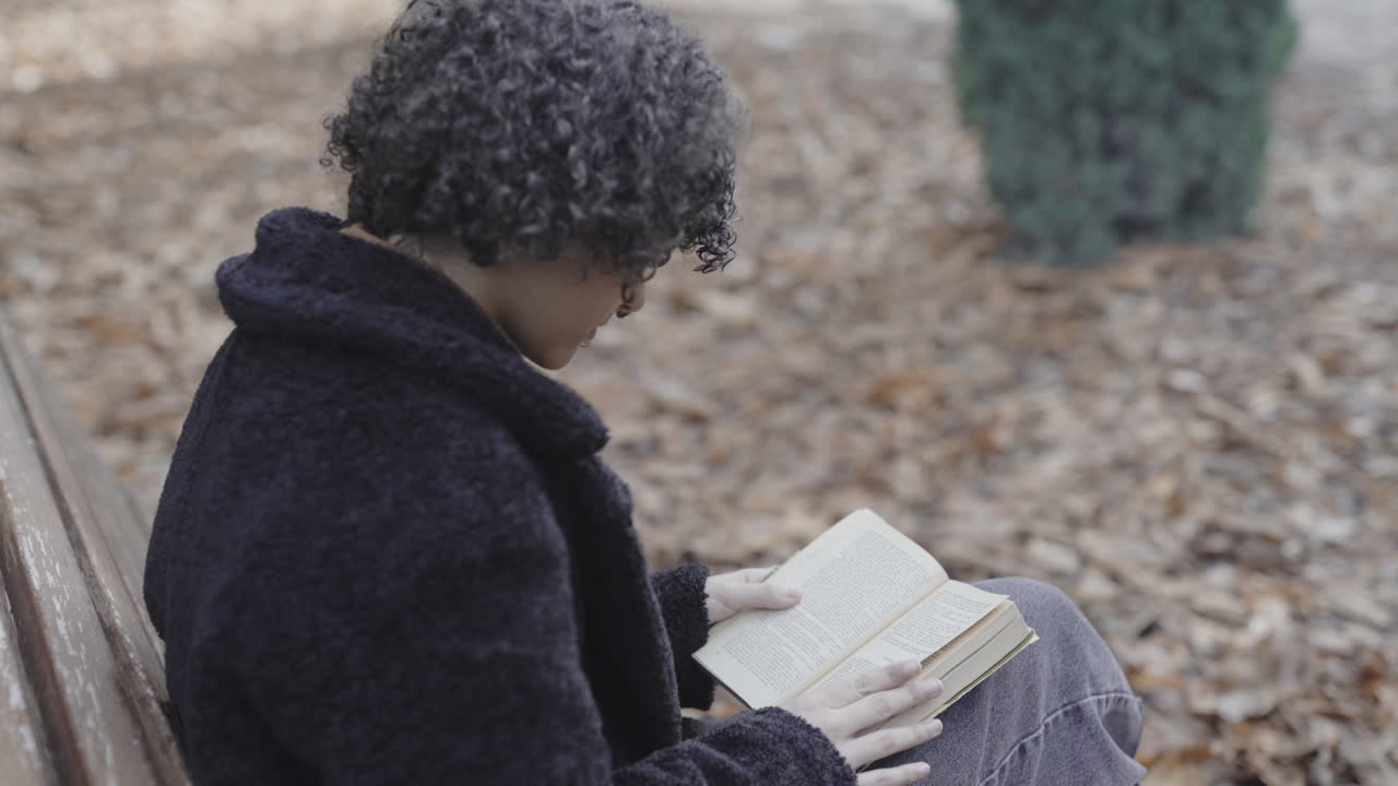 Engrossed introvert novel reading at autumn season