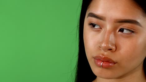 sliding shot of a gorgeous young asian woman looking away