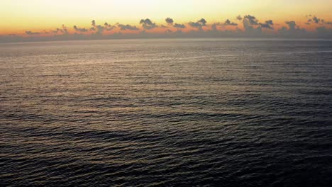 beautiful tilting up aerial drone landscape shot revealing a stunning colorful tropical sunrise in riviera maya near cancun, mexico on a warm summer morning.