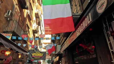 tourists explore vibrant street with italian flags