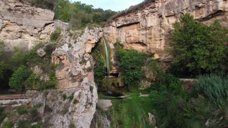 waterfall cascading through lush greenery in sant miquel del fai, barcelona, captured in natural daylight