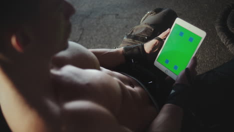 muscular man using tablet