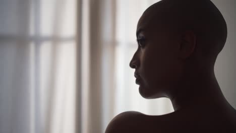 serious black woman in towel at home