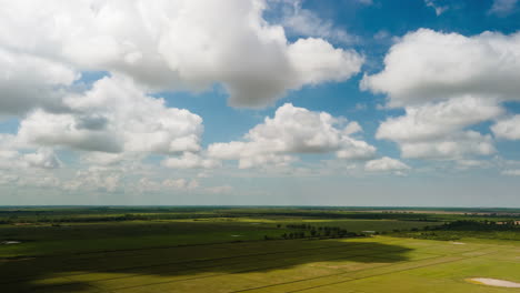 Cloud-formations-at-the-onset-of-Monsoon-season-with-vivid-blue-skyline-over-flat-lands-surrounding-the-Tomle-Sap-lake,-Cambodia