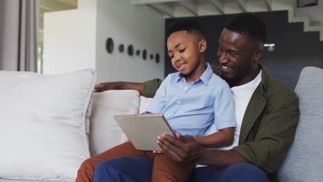 African-american-father-and-son-using-a-digital-tablet-together