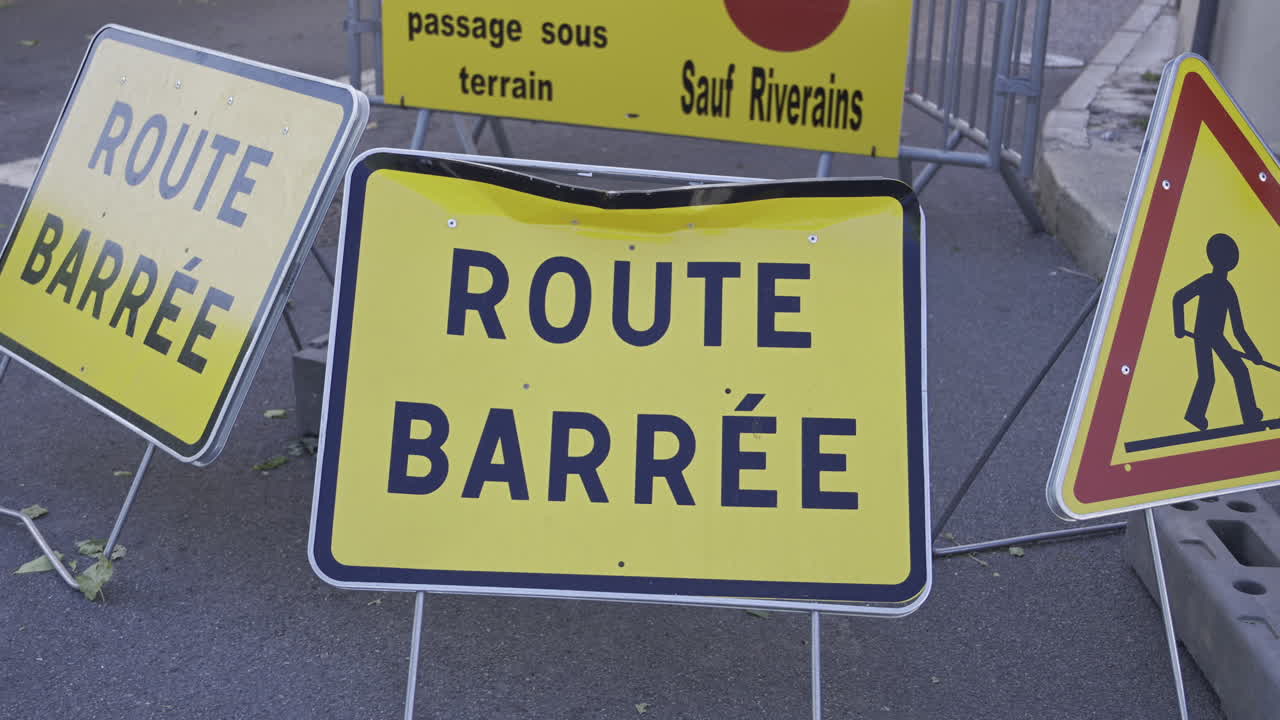 Close up of multiple French road signs indicating a blocked road