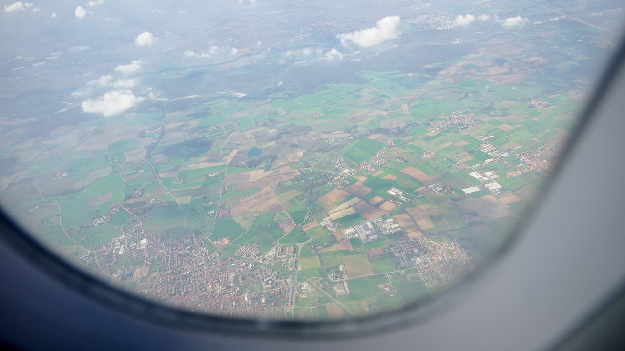 Aerial view of fields and towns from an airplane window